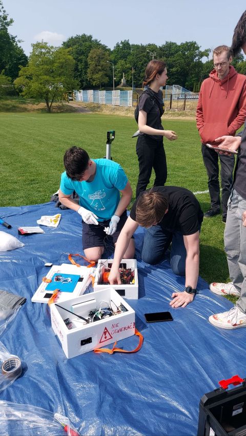 The team prepares the payload